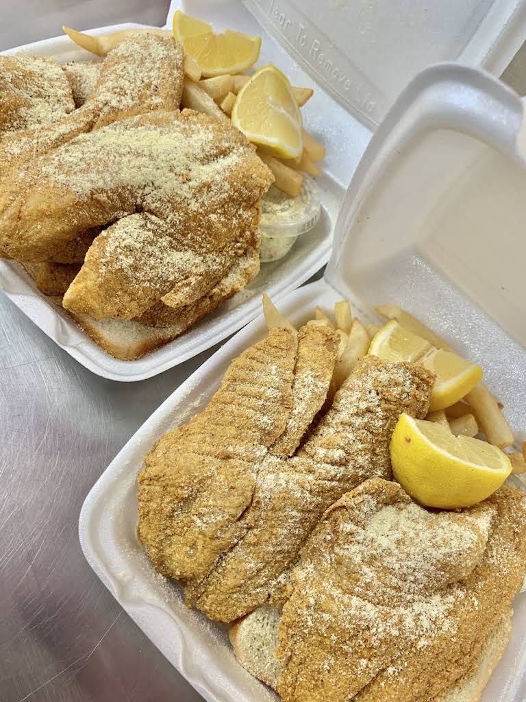 Seasoned golden fish dinners with fries and lemon, photographed by JJ Fish and Chicken Forest Park