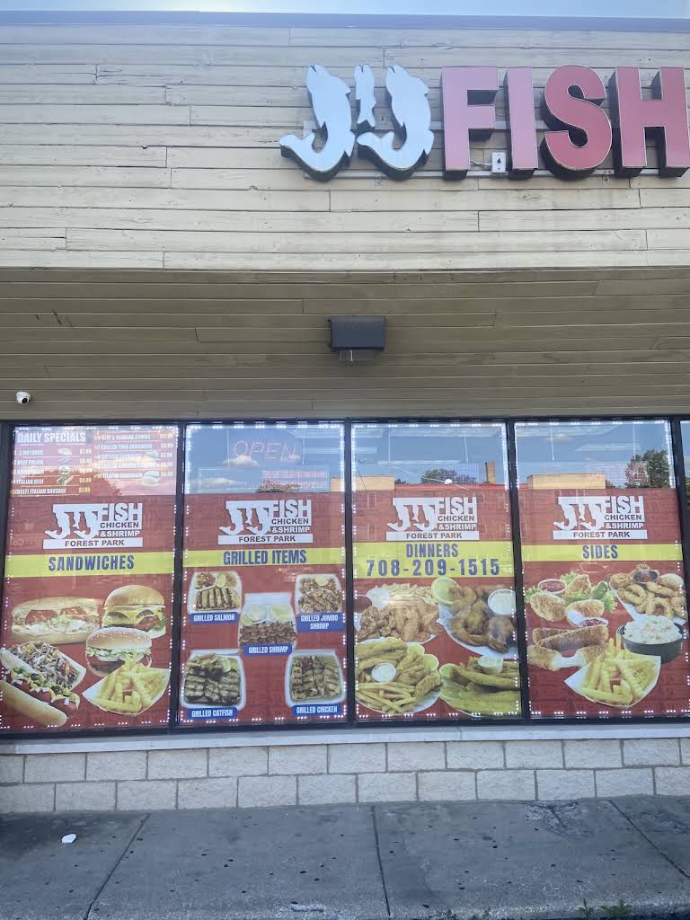 The JJ Fish and Chicken storefront on Harlem Avenue with red and yellow window signs
